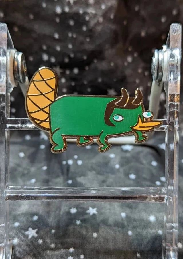 Green platypus with Lowkey horns. One inch length, half inch tall.