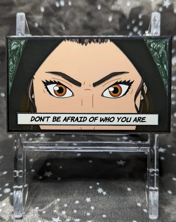 Rectangular pin of the dark version of our favorite scavenger in a black hood. Black swirled background. Quote on pin says "Don't be afraid of who you are."