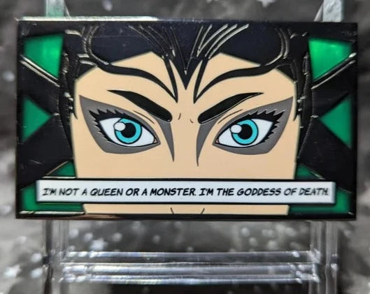 Rectangular pin of Hela's eyes with stained glass green background. Quote on pin says "I'm not a queen or a monster. I'm the goddess of death."